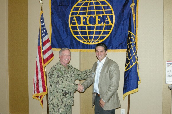 In April, Capt. Slevin congratulates Senton Pojani for his volunteer work at the 2013 Hillsborough Regional STEM Fair.